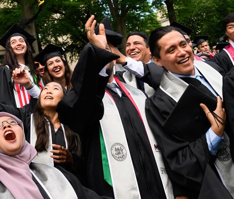 Omar and his MIT classmates throwing their caps at commencement