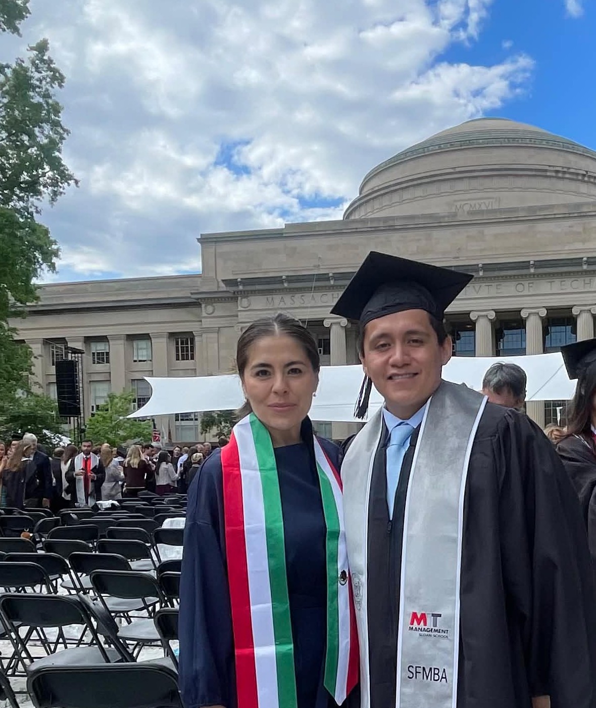Omar and Maggie in regalia at MIT commencement, the Great Dome behind them